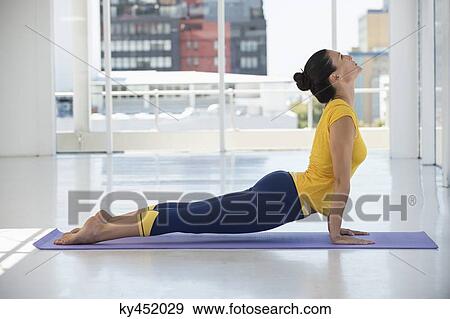 Woman exercising on exercise mat in a gym View Large Photo Image Stock Photo - Woman exercising on exercise mat in a gym. Fotosearch