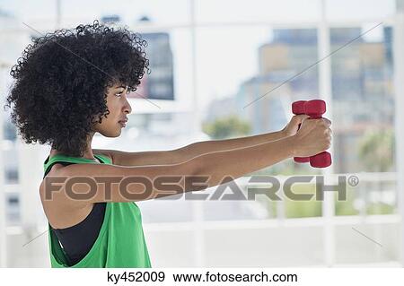 Woman exercising with dumbbells View Large Photo Image Stock Photo - Woman exercising with dumbbells. Fotosearch