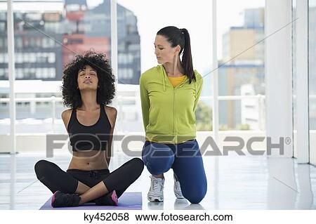 Woman exercising with her instructor in a gym View Large Photo Image Stock Photo - Woman exercising with her instructor in a gym. Fotosearch