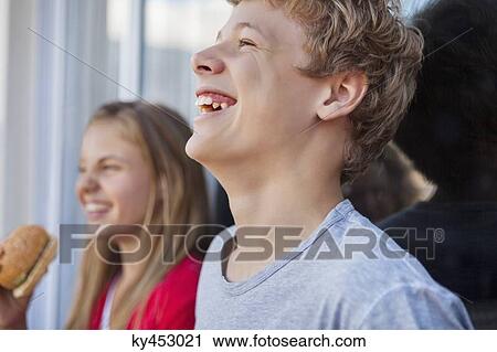 Stock Image - Close-up of friends smiling. Fotosearch