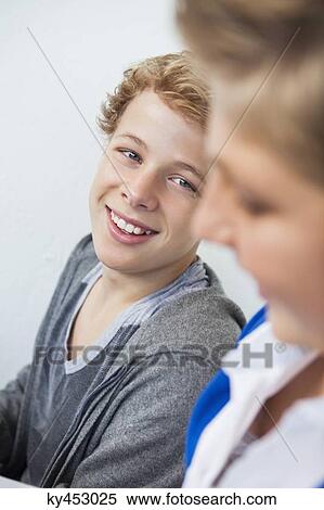 Stock Photography - Close-up of two teenage boys smiling. Fotosearch