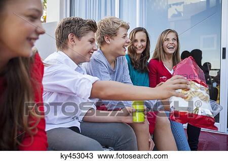 Friends enjoying fast food together View Large Photo Image Stock Image - Friends enjoying fast food together. Fotosearch