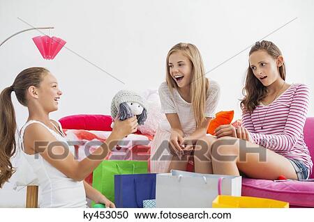 Girl showing a rag doll to her friends at a slumber party View Large Photo Image Stock Image - Girl showing a rag doll to her friends at a slumber party. Fotosearch