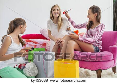 Stock Photo - Girls enjoying good time at a slumber party. Fotosearch