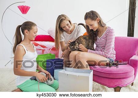 Girls playing with cat at a slumber party View Large Photo Image Stock Image - Girls playing with cat at a slumber party. Fotosearch