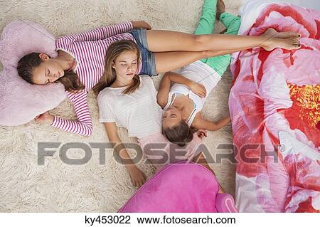 Girls sleeping on a carpet at a slumber party View Large Photo Image Stock Image - Girls sleeping on a carpet at a slumber party. Fotosearch