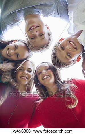 Low angle view of friends in a huddle View Large Photo Image Stock Image - Low angle view of friends in a huddle. Fotosearch