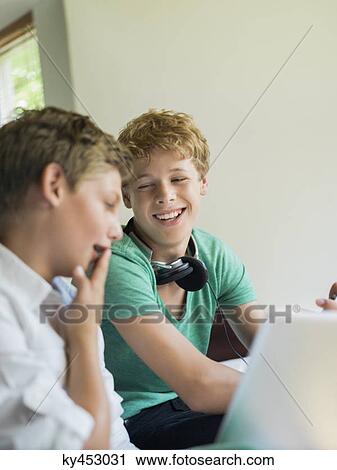 Two friends using a digital tablet View Large Photo Image Stock Image - Two friends using a digital tablet. Fotosearch