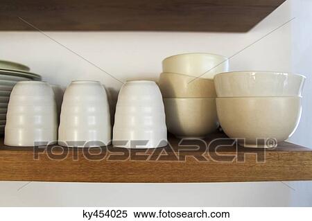 Bowls and glasses in a shelf View Large Photo Image Stock Photography - Bowls and glasses in a shelf. Fotosearch