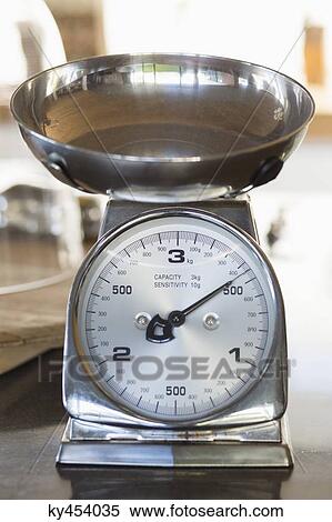 Close-up of a weighing scale at a kitchen counter View Large Photo Image Stock Photography - Close-up of a weighing scale at a kitchen counter. Fotosearch