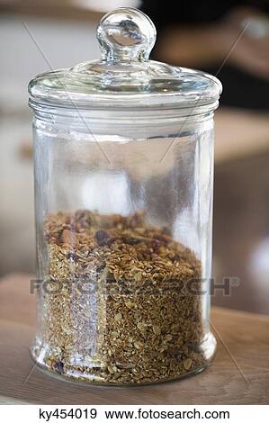 Granola in a jar at a kitchen counter View Large Photo Image Stock Photo - Granola in a jar at a kitchen counter. Fotosearch