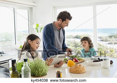 Man preparing food for his children View Large Photo Image Stock Photo - Man preparing food for his children. Fotosearch