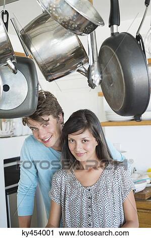 Portrait of a couple smiling in the kitchen View Large Photo Image Stock Image - Portrait of a couple smiling in the kitchen. Fotosearch