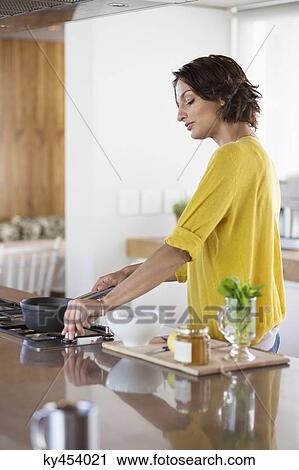 Woman cooking in the kitchen View Large Photo Image Stock Image - Woman cooking in the kitchen. Fotosearch