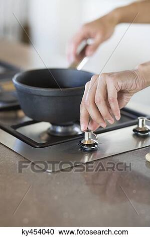 Woman cooking in the kitchen View Large Photo Image Stock Image - Woman cooking in the kitchen. Fotosearch