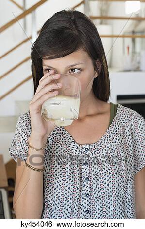 Woman drinking a glass of juice View Large Photo Image Stock Photograph - Woman drinking a glass of juice. Fotosearch