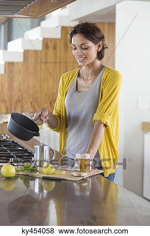 Woman preparing herbal tea in the kitchen View Large Photo Image Stock Photo - Woman preparing herbal tea in the kitchen. Fotosearch