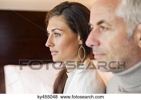 Couple sitting together in a hotel room View Large Photo Image Stock Photo - Couple sitting together in a hotel room. Fotosearch