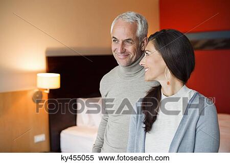 Stock Photography - Couple smiling in a hotel room. Fotosearch