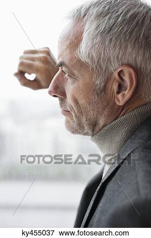 Stock Photo - Man looking through a window. Fotosearch