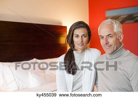 Portrait of a couple sitting in a hotel room View Large Photo Image Stock Photo - Portrait of a couple sitting in a hotel room. Fotosearch