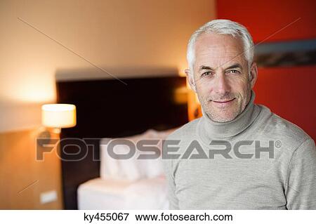 Stock Photo - Portrait of a man in a hotel room. Fotosearch