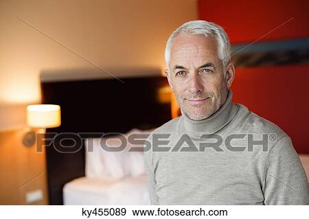 Stock Photo - Portrait of a man in a hotel room. Fotosearch