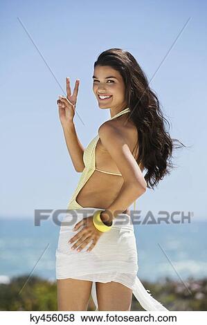 Beautiful woman gesturing on the beach View Large Photo Image Stock Photo - Beautiful woman gesturing on the beach. Fotosearch