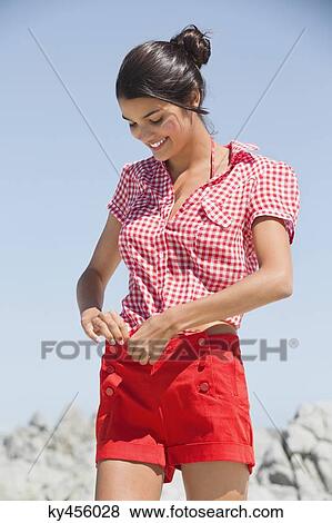 Beautiful woman getting dressed on the beach View Large Photo Image Stock Photo - Beautiful woman getting dressed on the beach. Fotosearch