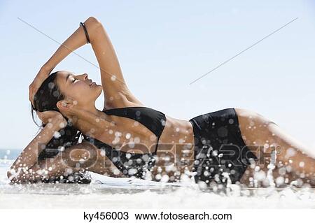 Beautiful woman in bikini posing on the beach View Large Photo Image Stock Image - Beautiful woman in bikini posing on the beach. Fotosearch