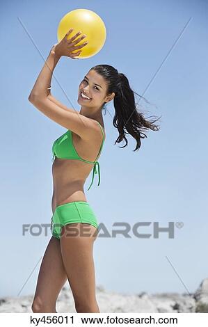 Beautiful woman playing with a ball on the beach View Large Photo Image Stock Image - Beautiful woman playing with a ball on the beach. Fotosearch