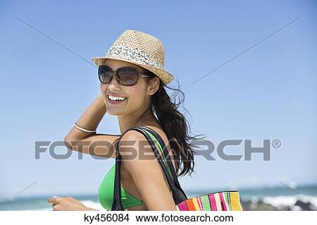 Beautiful woman smiling on the beach View Large Photo Image Picture - Beautiful woman smiling on the beach. Fotosearch