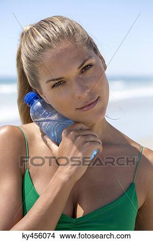 Portrait of a woman holding a water bottle View Large Photo Image Picture - Portrait of a woman holding a water bottle. Fotosearch
