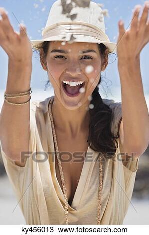 Woman playing with sand on the beach View Large Photo Image Stock Image - Woman playing with sand on the beach. Fotosearch