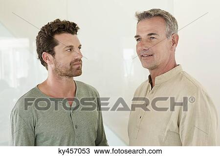 Man looking at his father smiling View Large Photo Image Stock Image - Man looking at his father smiling. Fotosearch