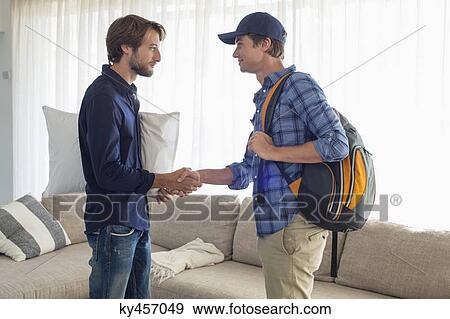 Stock Photo - Man shaking hands with his friend. Fotosearch