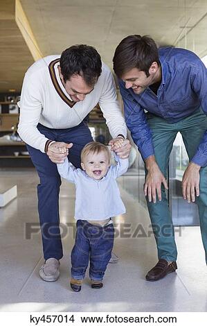 Parents helping their son to walk View Large Photo Image Picture - Parents helping their son to walk. Fotosearch