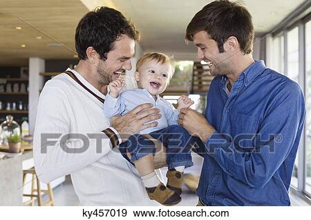 Parents smiling with their son at home View Large Photo Image Stock Photo - Parents smiling with their son at home. Fotosearch