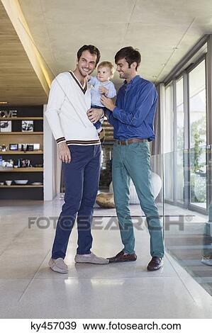 Stock Photo - Parents smiling with their son at home. Fotosearch