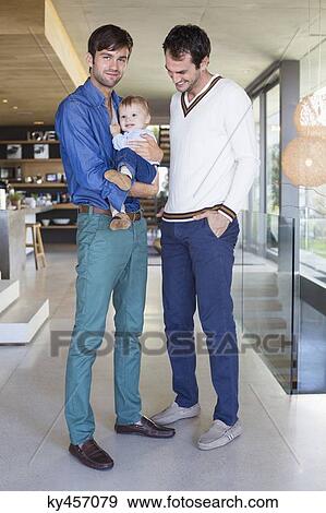 Stock Photo - Parents smiling with their son at home. Fotosearch