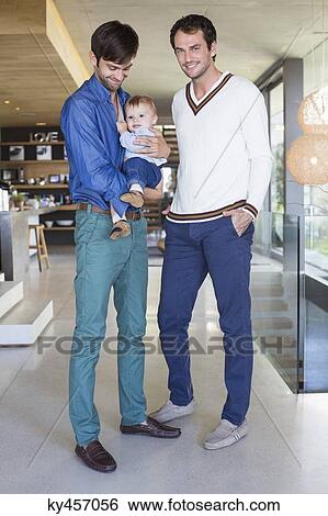 Parents smiling with their son at home View Large Photo Image Stock Photograph - Parents smiling with their son at home. Fotosearch