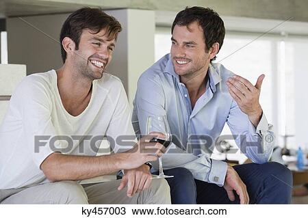 Smiling male friends with red wine View Large Photo Image Stock Image - Smiling male friends with red wine. Fotosearch