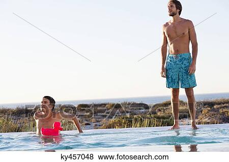 Stock Photo - Two friends at swimming pool. Fotosearch