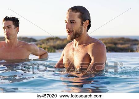 Two friends enjoying in a swimming pool View Large Photo Image Stock Image - Two friends enjoying in a swimming pool. Fotosearch