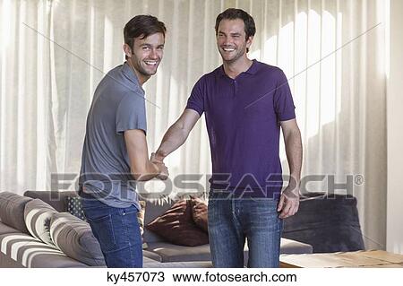 Two friends shaking hands and smiling View Large Photo Image Stock Image - Two friends shaking hands and smiling. Fotosearch