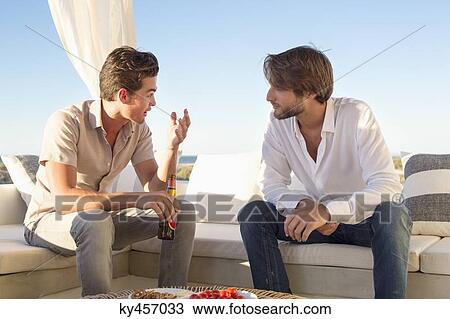 Stock Image - Two friends talking to each other. Fotosearch