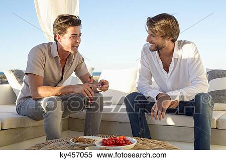 Stock Photography - Two friends talking to each other. Fotosearch