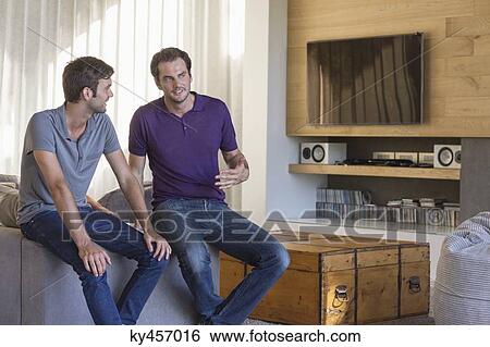 Stock Photograph - Two male friends discussing. Fotosearch
