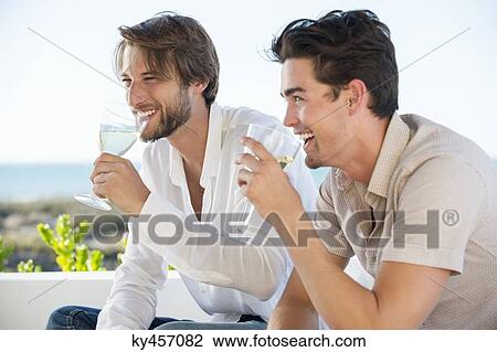 Two male friends enjoying white wine in outdoor View Large Photo Image Stock Image - Two male friends enjoying white wine in outdoor. Fotosearch