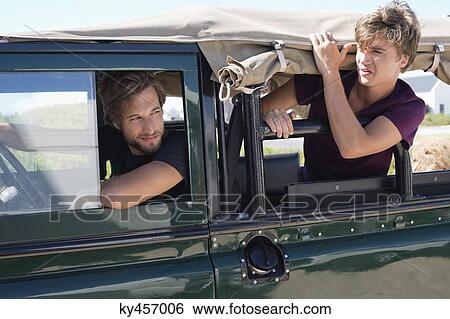 Two male friends in a SUV View Large Photo Image Stock Photograph - Two male friends in a SUV. Fotosearch